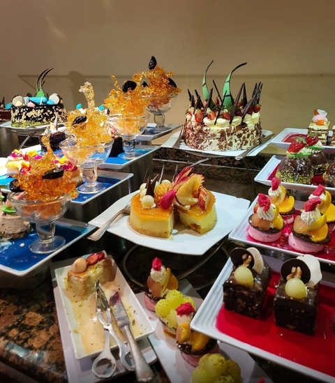 Display of various colorful desserts and pastries.