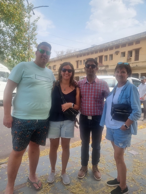       Group of people posing on a street.
  
