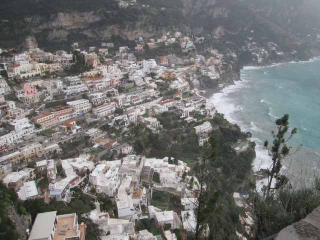 Aerial view of a coastal city with buildings along the shore.