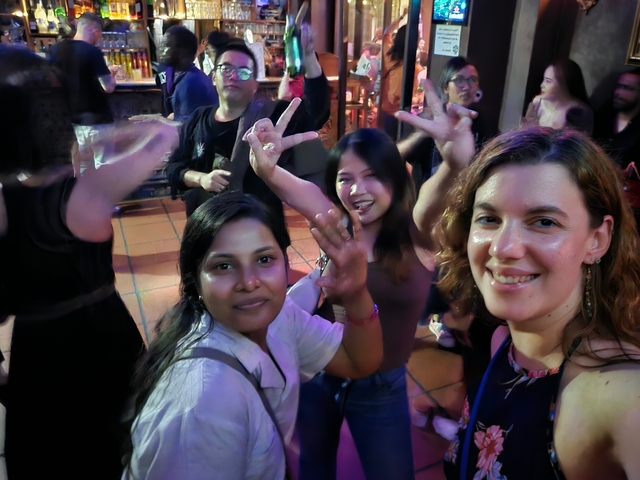       Group having fun at a night event with dancing.
  