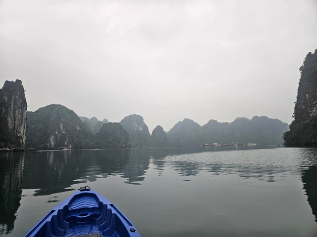       Calm waters with scenic mountainous backdrop.
  