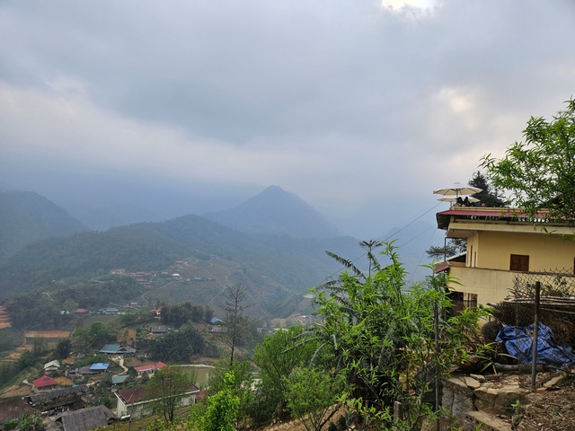       Distant view of a mountain range with a cloudy sky.
  