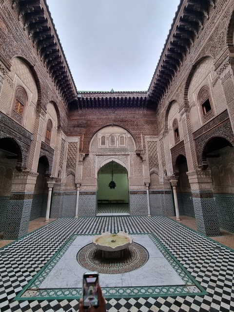 Ornately decorated interior courtyard with arches.