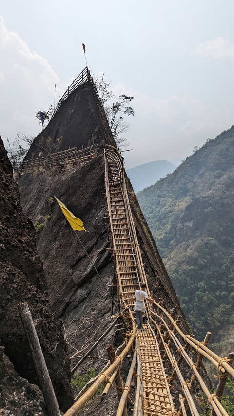       Steep bamboo bridge on a mountain slope
  