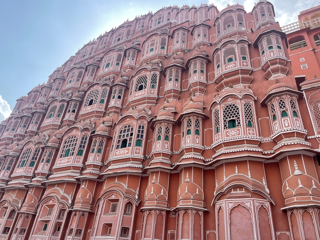       Ornate pink building facade with numerous windows.
  