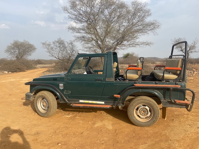 Off-road vehicle in a desert landscape.