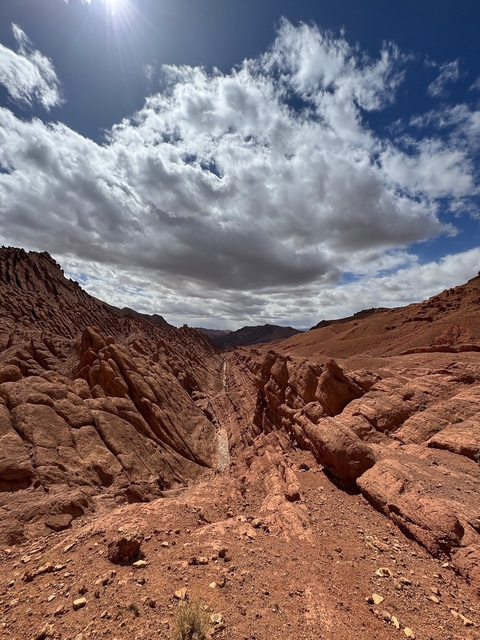       Jagged rock formations under a cloudy sky.
  