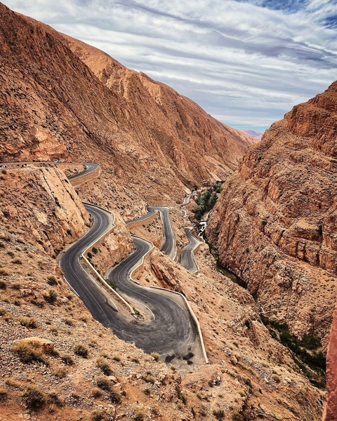       Winding road through rugged cliffs.
  