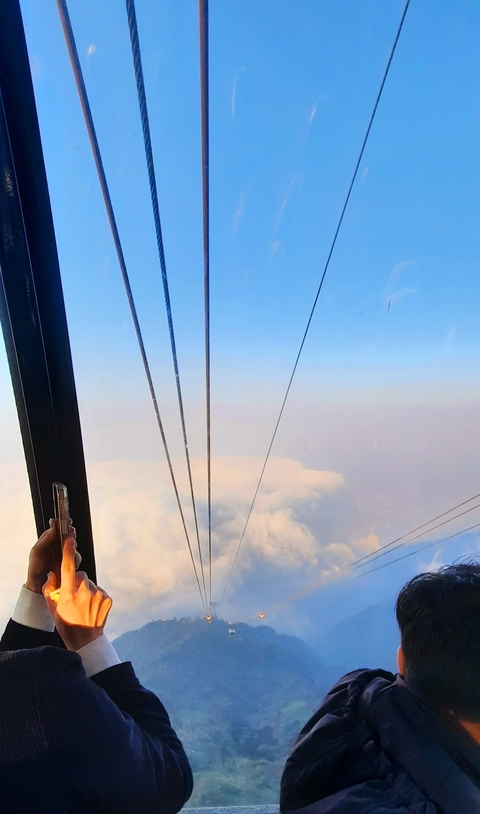 View from a cable car above the clouds.