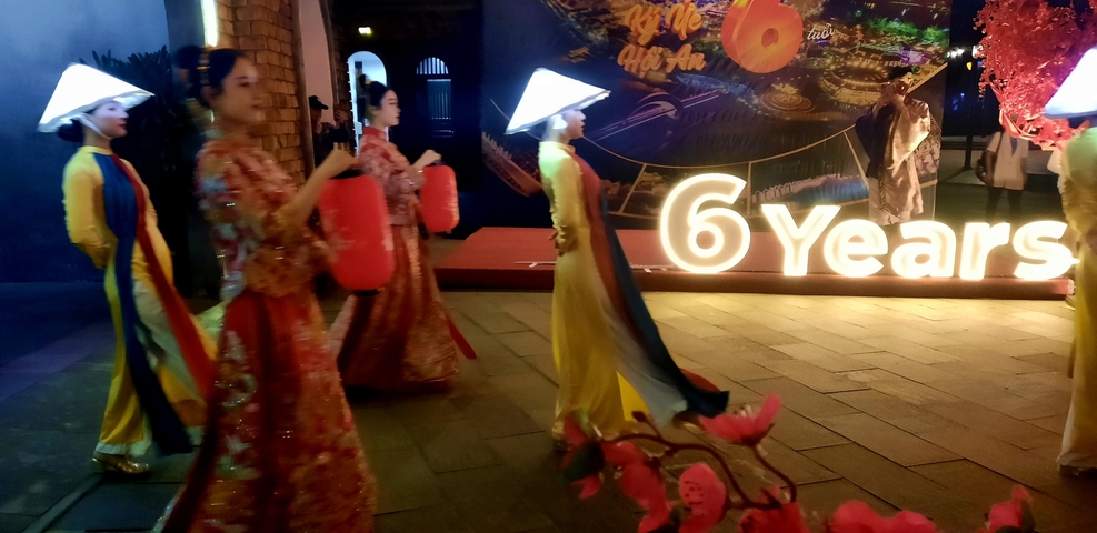       Festival with people wearing traditional clothing.
  