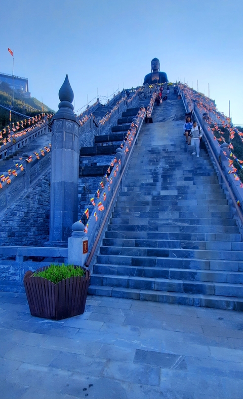Stone steps decorated with flags leading upwards.