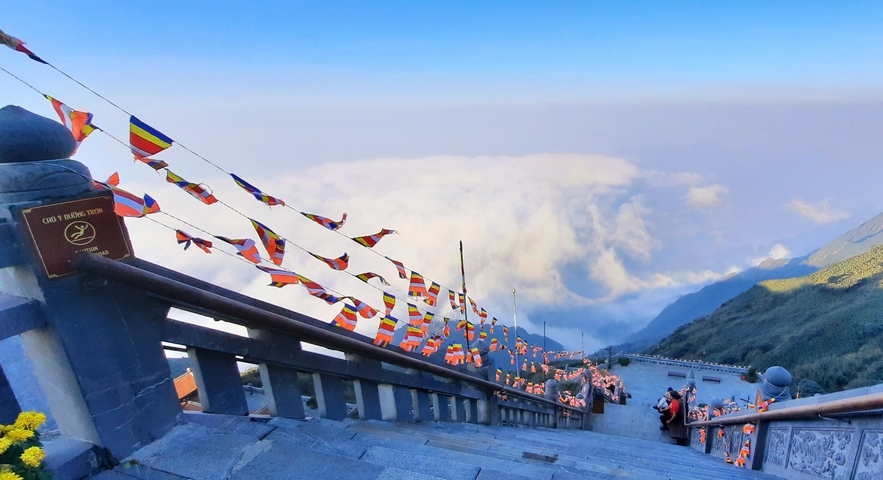       View from a high staircase overlooking the clouds.
  