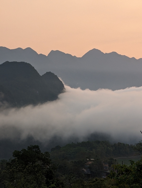 Scenic landscape with mountains partially covered by mist.