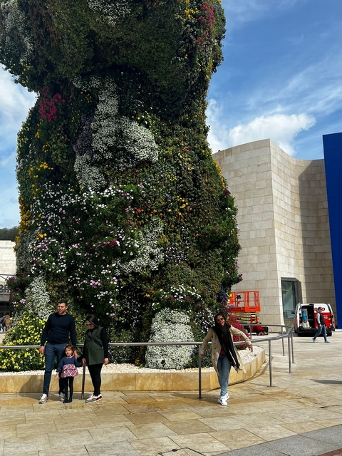 Large floral sculpture near a modern building.