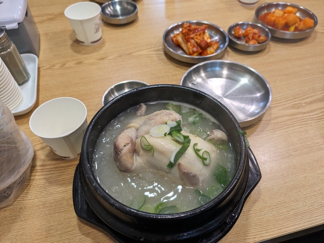 Soup with a whole chicken in a bowl.