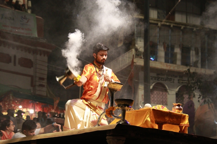       Man performing a religious ceremony with incense
  