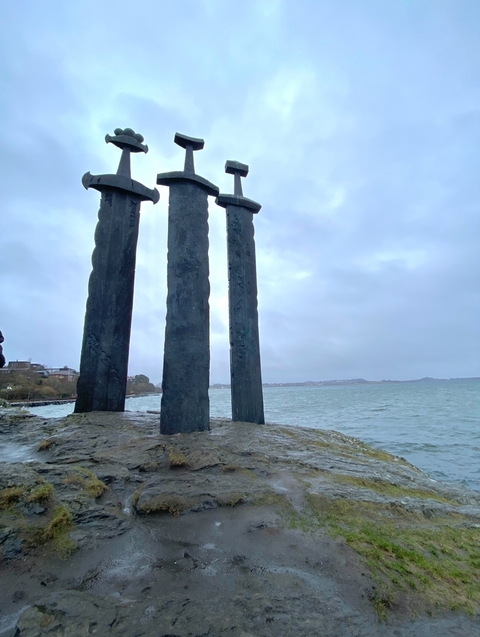       Monument with large swords by the sea
  
