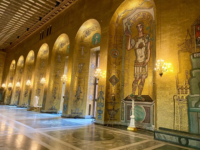 Ornate hall with golden mosaics and arches