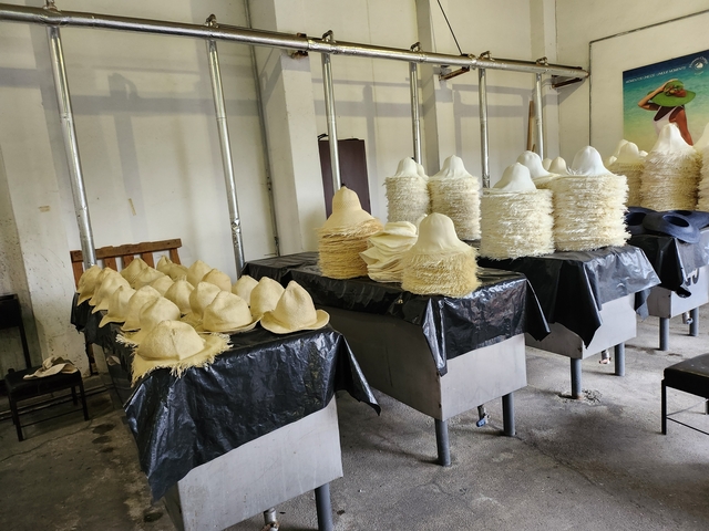       Rows of straw hats on display.
  
