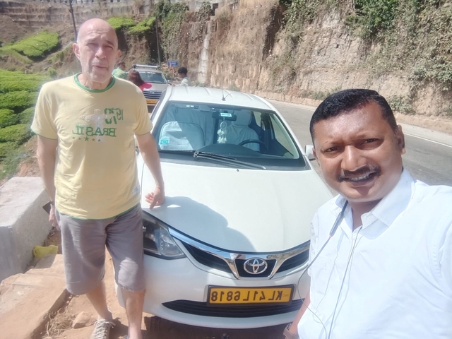 Selfie with two people in front of a car