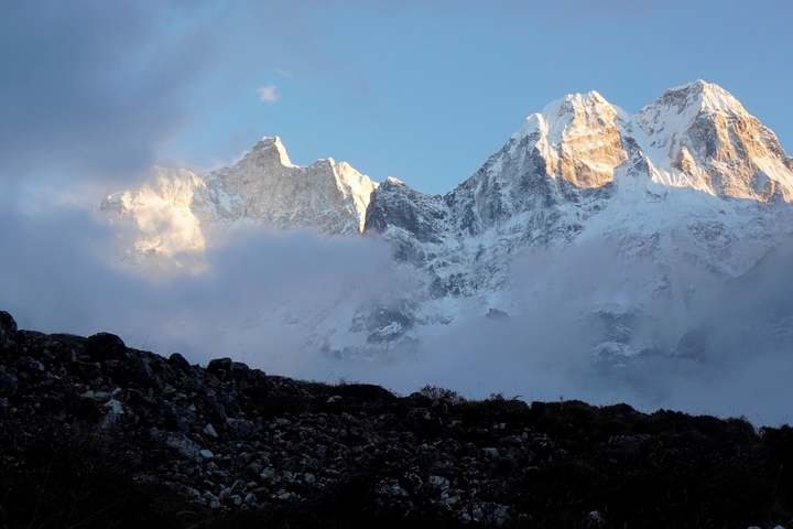 Snow-capped mountains with a cloudy sky.