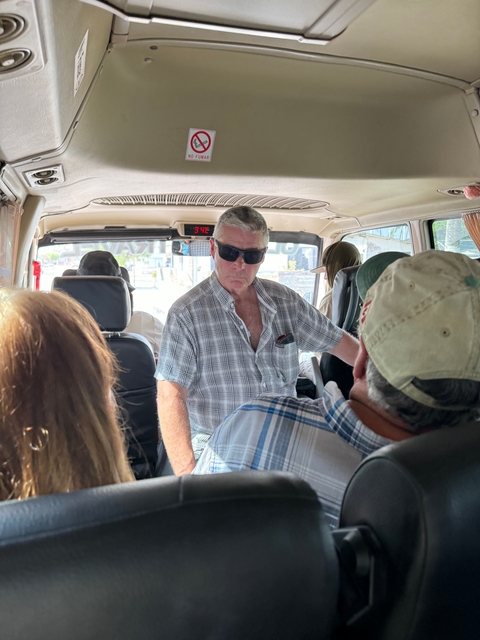 Interior of a van with a group of travelers.