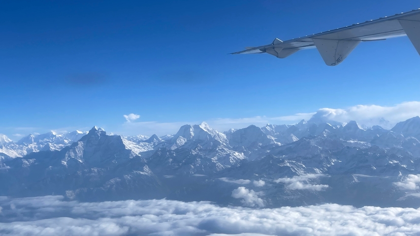 Snow-covered mountains viewed from an airplane.