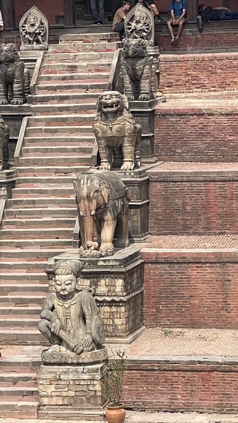       Stone statue of an elephant on steps.
  