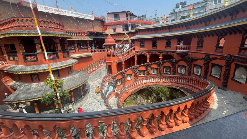       Red temple complex with ornate architecture.
  