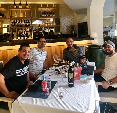 Group of people dining at a restaurant table.