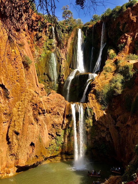 Series of cascading waterfalls in a rocky environment.