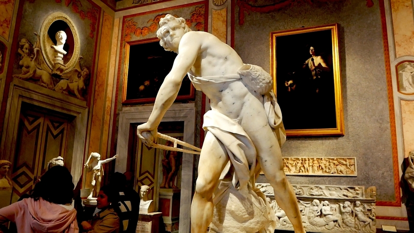       Statue of David inside a museum gallery.
  