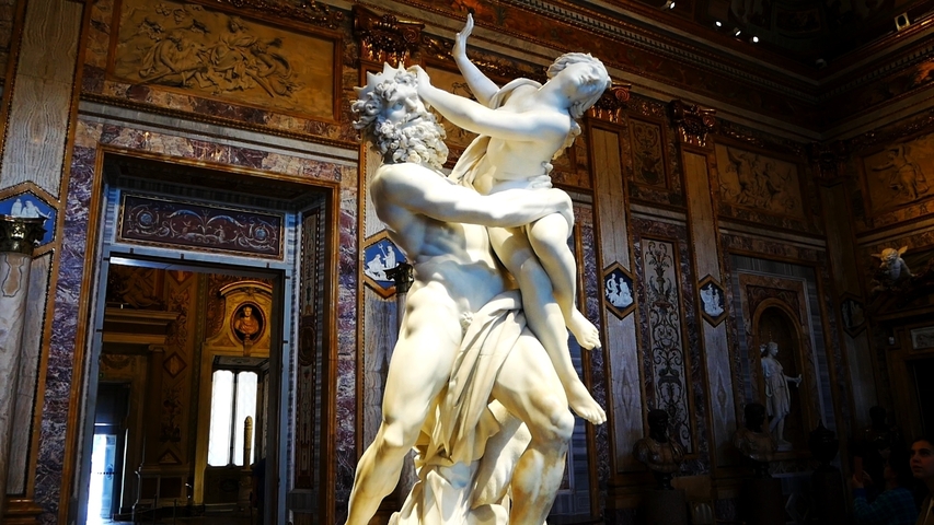       Rape of Sabine Women statue inside a museum.
  