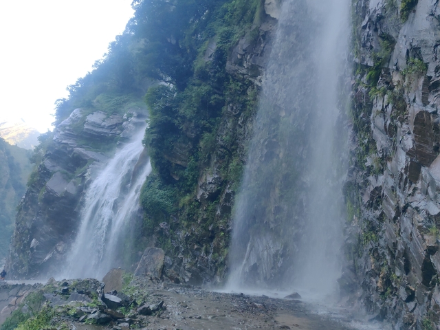 Tall waterfall cascading over rocky cliff