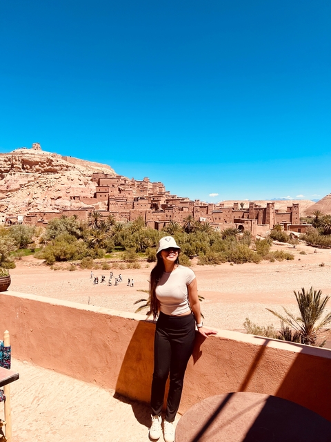      Person posing with Ait Benhaddou in the background.
  