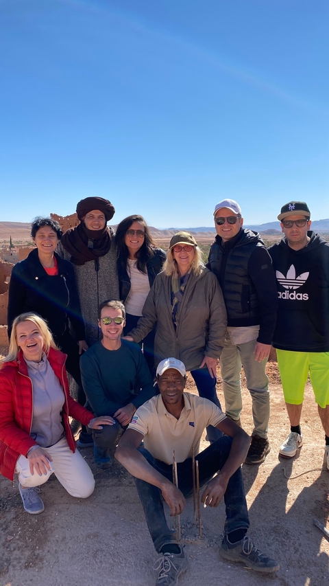 Group posing with mountains in the background.