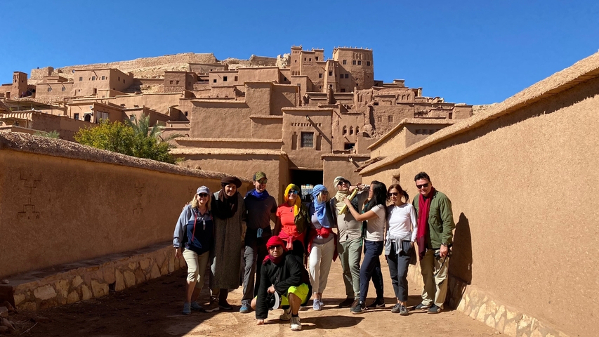       Group posing in front of Ait Benhaddou.
  