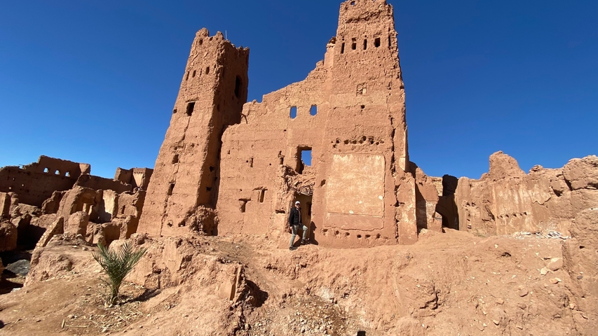Ruins of an ancient structure with clear blue sky.