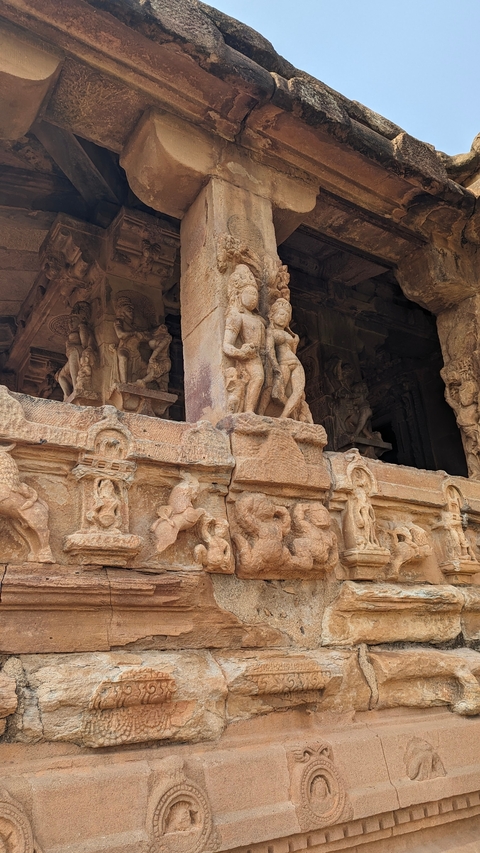       Stone carvings depicting figures on an ancient Indian temple.
  