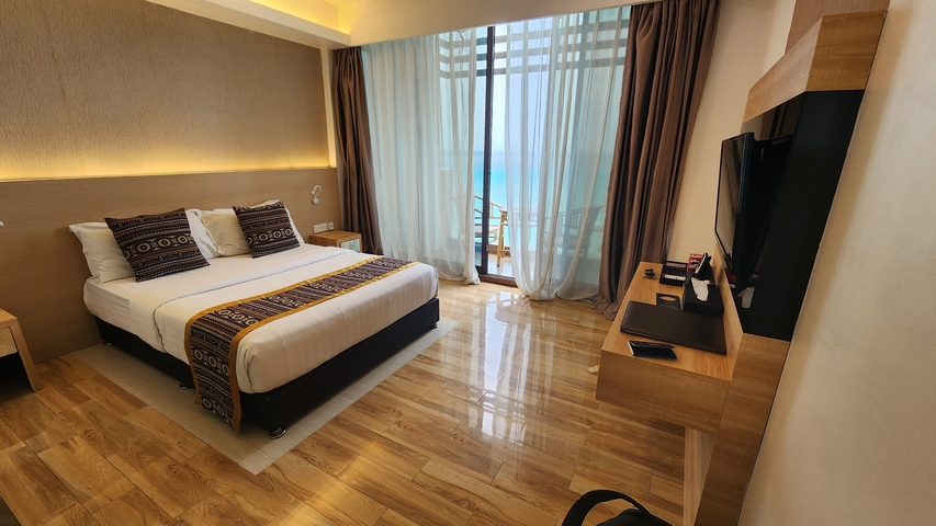 Hotel room with a view of the ocean.