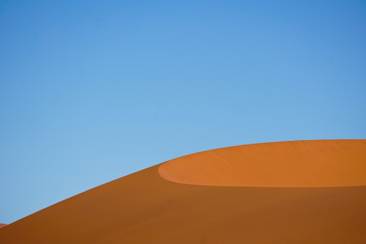 Dune landscape with a clear blue sky in the desert.