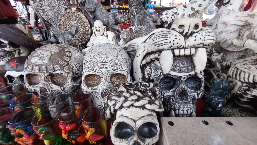      Various skull decorations on display in a market.
  