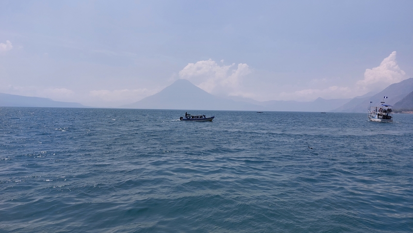      Lake with a distant view of a mountain under a clear sky.
  