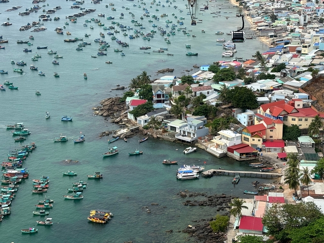 Aerial view of a coastal settlement with boats on the water.