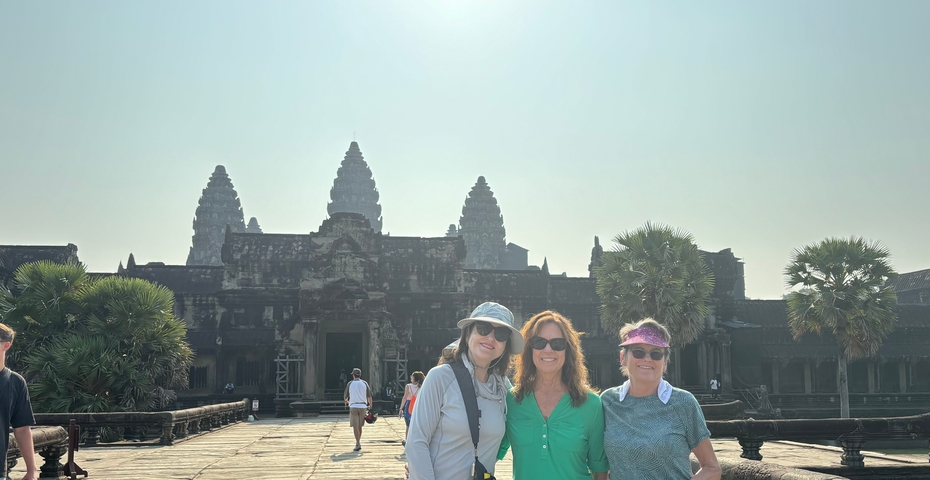Group posing in front of the Angkor Wat temple complex.