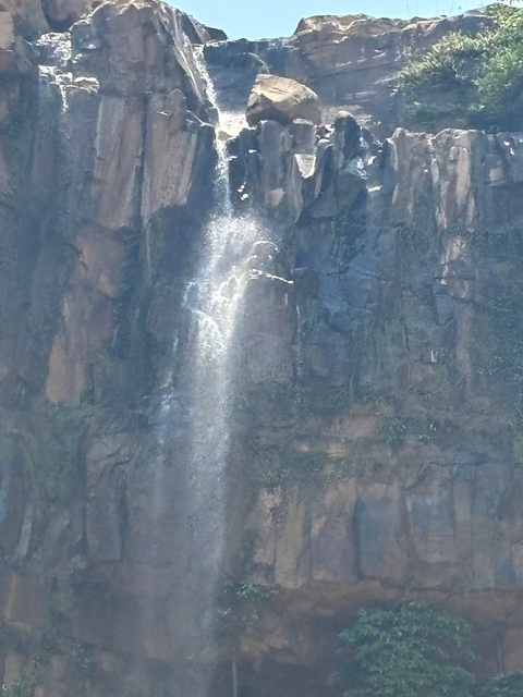       Waterfall cascading down a rocky cliff.
  