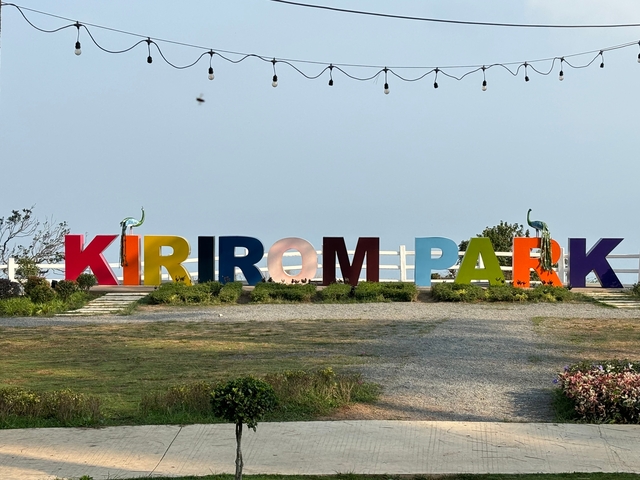       Colorful sign reading 'Kirirom Park' with a clear sky.
  
