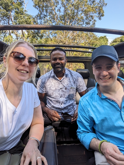 Three people smiling in a vehicle.