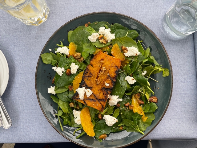       Plate of salad with roasted pumpkin and goat cheese.
  
