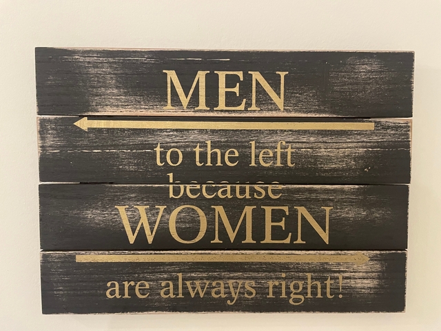       Sign with humorous text about men and women directions.
  